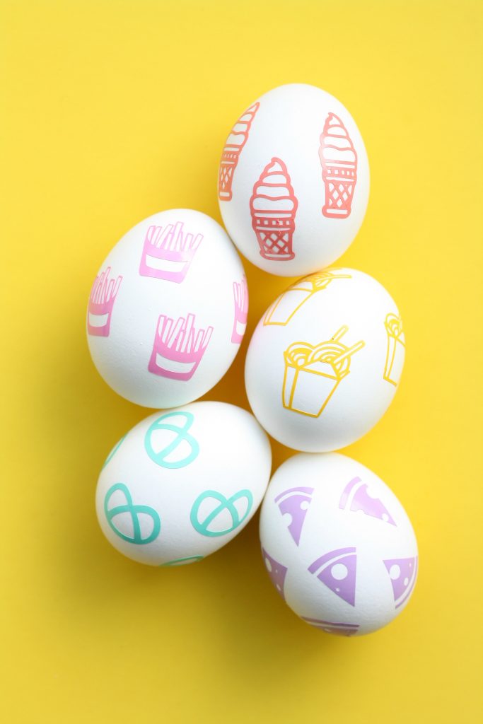 eggs on yellow background with food shaped stickers